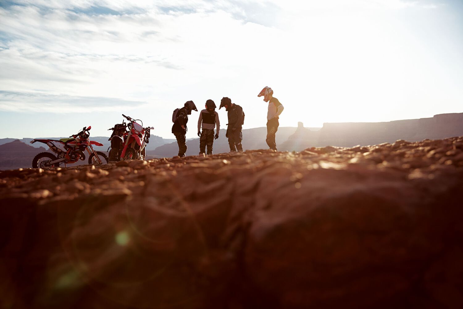 A group of enduro riders off their bikes and talking.